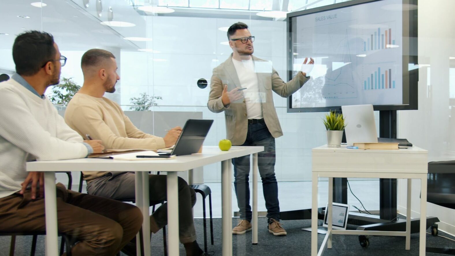 Professional business meeting with presentation of data analytics in modern office setting.